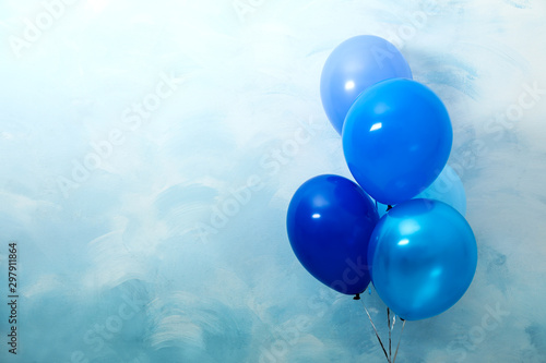 Bunch of balloons on light blue background, space for text. Greeting card photo