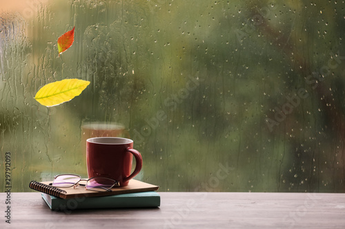 фотографія Composition with cup of drink and autumn leaf on windowsill, space for text