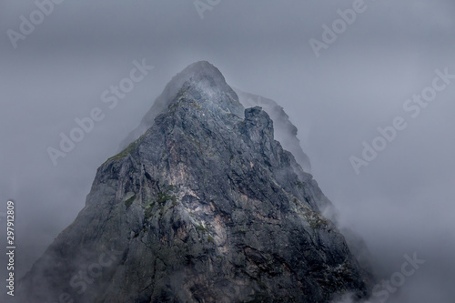 A stunning, mysterious peak shrouded in mist at Rila mountain in Bulgaria. Maliovica. photo