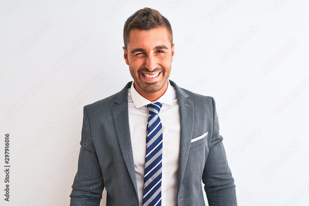 Young handsome business man wearing suit and tie over isolated background winking looking at the camera with sexy expression, cheerful and happy face. Young handsome business man wearing suit and tie over isolated background winking looking at the camera with sexy expression, cheerful and happy face.