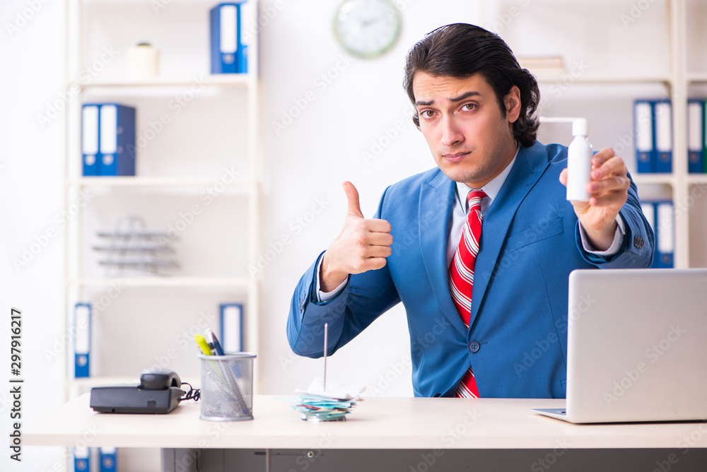 Young male employee suffering in the office Young male employee suffering in the office
