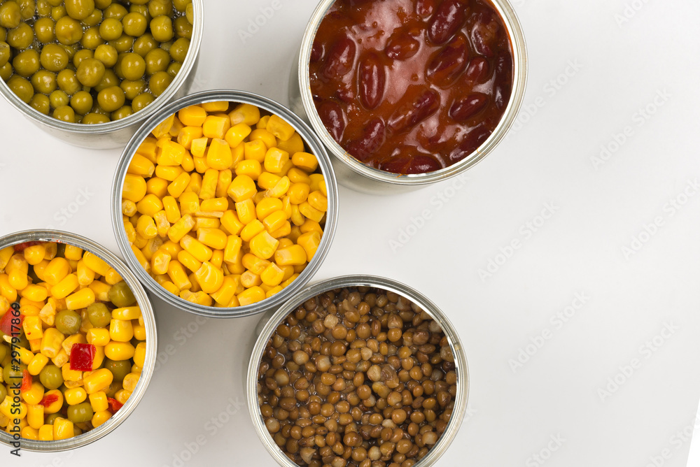 Canned food on white background. Green pea, beans, corn, lentils. Canned food on white background. Green pea, beans, corn, lentils.