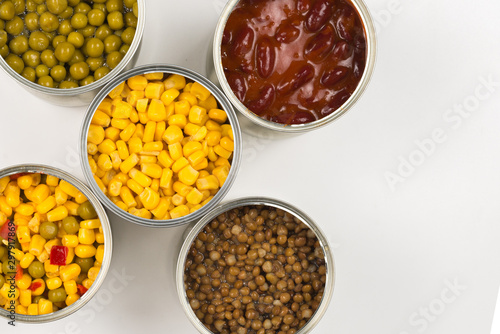 Canned food on white background. Green pea, beans, corn, lentils.