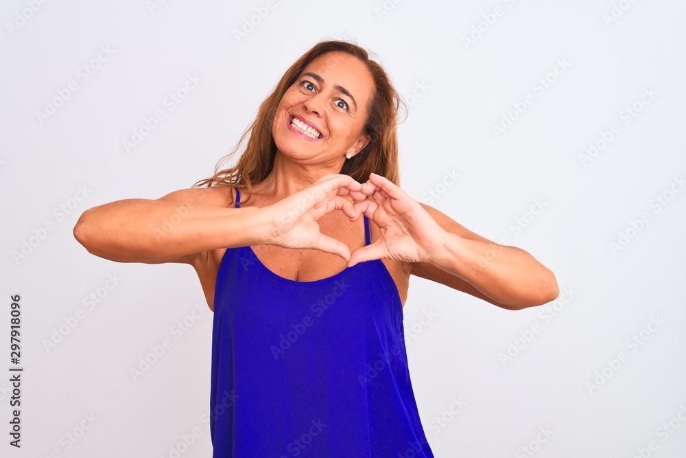 Middle age mature woman standing over white isolated background smiling in love doing heart symbol shape with hands. Romantic concept. Middle age mature woman standing over white isolated background smiling in love doing heart symbol shape with hands. Romantic concept.