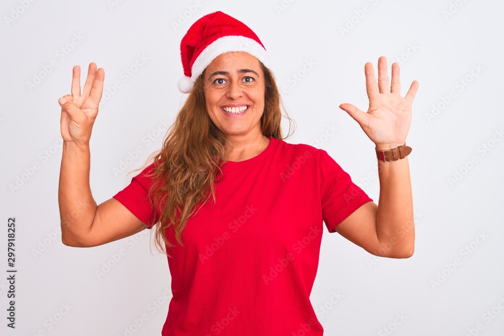 Middle age mature woman wearing christmas hat over isolated background showing and pointing up with fingers number eight while smiling confident and happy. Middle age mature woman wearing christmas hat over isolated background showing and pointing up with fingers number eight while smiling confident and happy.