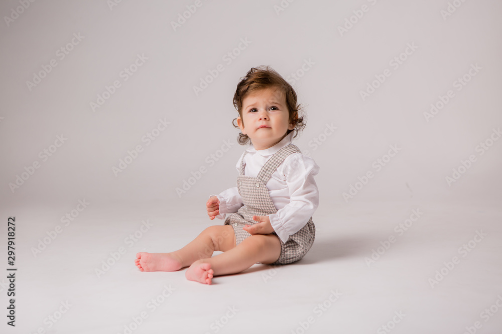 baby girl curly brunette 6 months on white background, space for text baby girl curly brunette 6 months on white background, space for text
