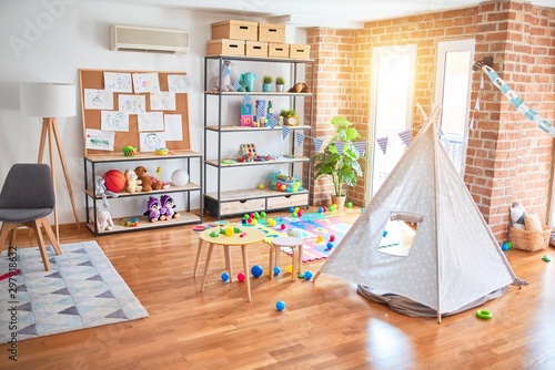 Picture of preschool playroom with colorful furniture, and toys around empty kindergarten