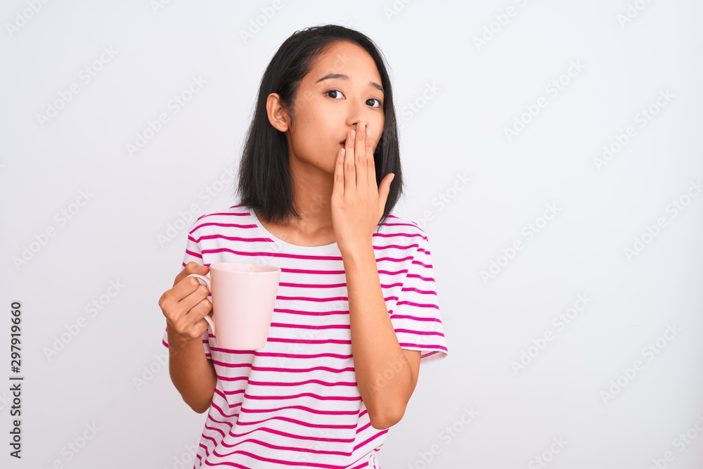 Young beautiful chinese woman drinking cup of coffee over isolated white background cover mouth with hand shocked with shame for mistake, expression of fear, scared in silence, secret concept Young beautiful chinese woman drinking cup of coffee over isolated white background cover mouth with hand shocked with shame for mistake, expression of fear, scared in silence, secret concept