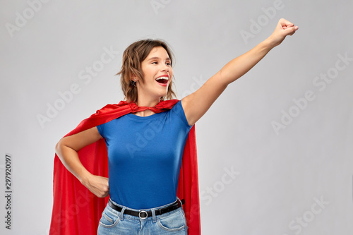 Bild auf Leinwand women's power and people concept - happy woman in red superhero cape making flyi