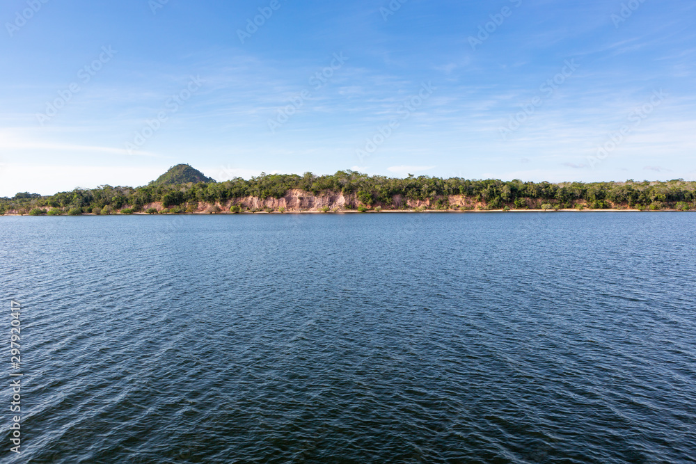 Panoramic view of Rio Tapajos in sunny summer day with rainforest, hills and beaches in Alter do Chao village, Pará, Brazil. Travel, amazon, vacation, adventure, environment and conservation concept.