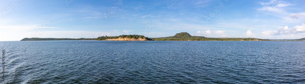 Panoramic view of Rio Tapajos in sunny summer day with rainforest, hills and beaches in Alter do Chao village, Pará, Brazil. Travel, amazon, vacation, adventure, environment and conservation concept. Panoramic view of Rio Tapajos in sunny summer day with rainforest, hills and beaches in Alter do Chao village, Pará, Brazil. Travel, amazon, vacation, adventure, environment and conservation concept.