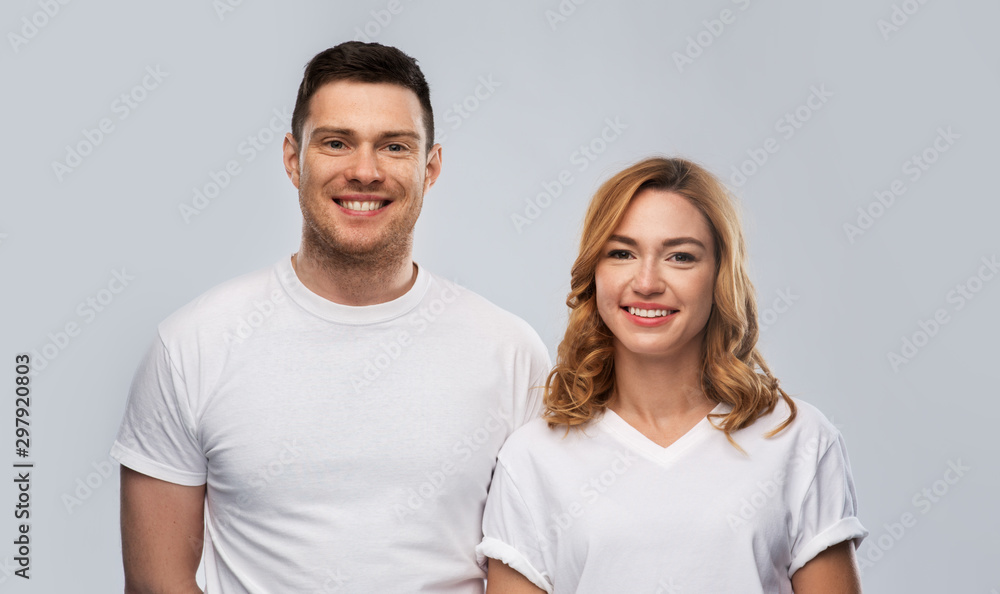 relationships and people concept - portrait of happy couple in white t-shirts over grey background relationships and people concept - portrait of happy couple in white t-shirts over grey background