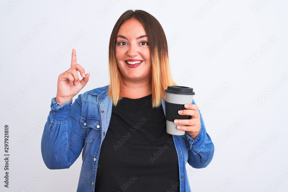 Young beautiful woman drinking take away glass of coffee over isolated white background surprised with an idea or question pointing finger with happy face, number one Young beautiful woman drinking take away glass of coffee over isolated white background surprised with an idea or question pointing finger with happy face, number one