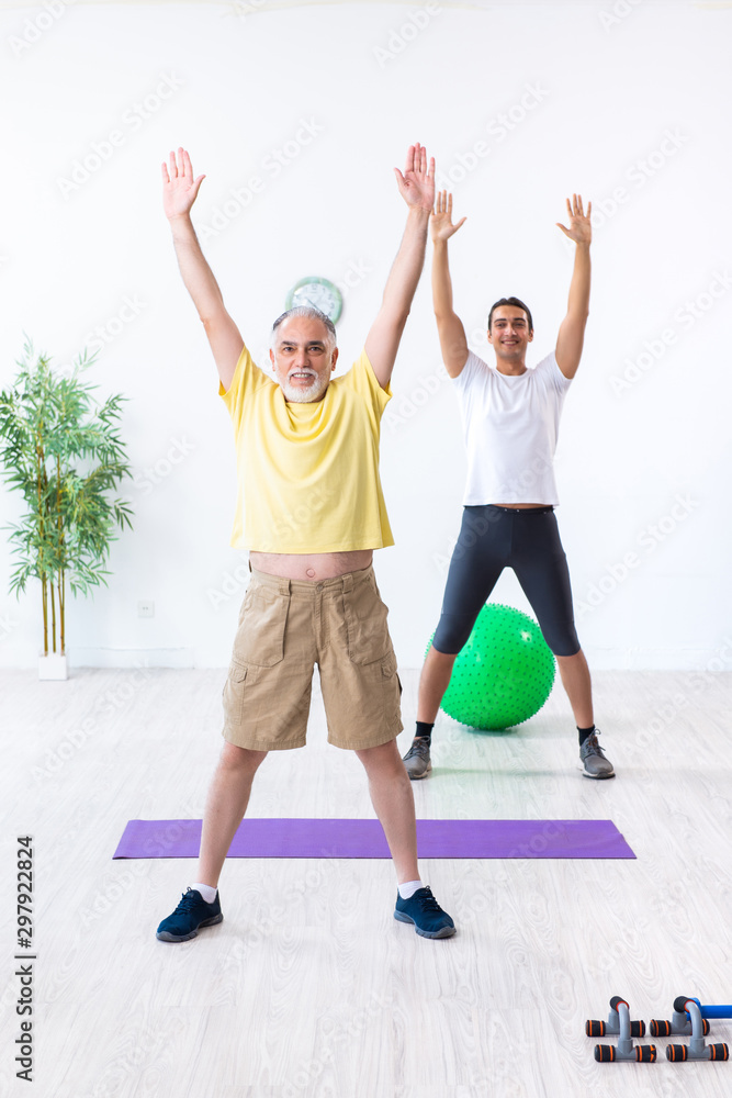 Old man doing exercises indoors