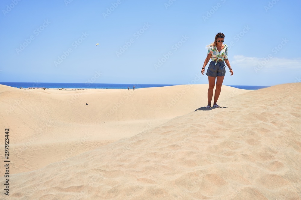 Young beautiful girl on vacation wearing summer clothes smiling happy and confident. Standing with a smile on face at beach Young beautiful girl on vacation wearing summer clothes smiling happy and confident. Standing with a smile on face at beach