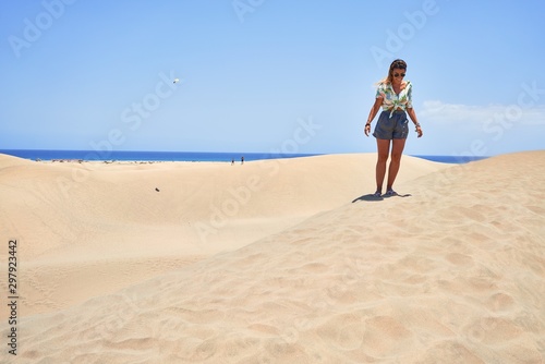 Young beautiful girl on vacation wearing summer clothes smiling happy and confident. Standing with a smile on face at beach