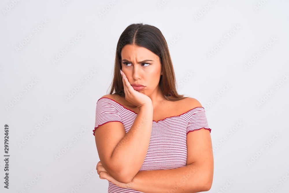 Portrait of beautiful young woman standing over isolated white background thinking looking tired and bored with depression problems with crossed arms. Portrait of beautiful young woman standing over isolated white background thinking looking tired and bored with depression problems with crossed arms.