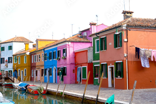 Colorful houses in Burano island. Canal view with boats. Travel photo. Venice. Italy. Europe. © Viktoras