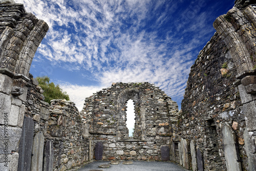 window view to Monastic cemetery of Glendalough, Ireland. Famous ancient monastery in the wicklow mountains with a beautiful graveyard from the 11th century 
