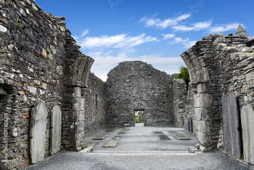 window view to Monastic cemetery of Glendalough, Ireland. Famous ancient monastery in the wicklow mountains with a beautiful graveyard from the 11th century 