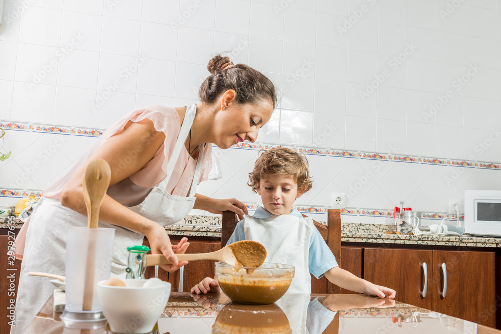 A woman and a child cooking together.