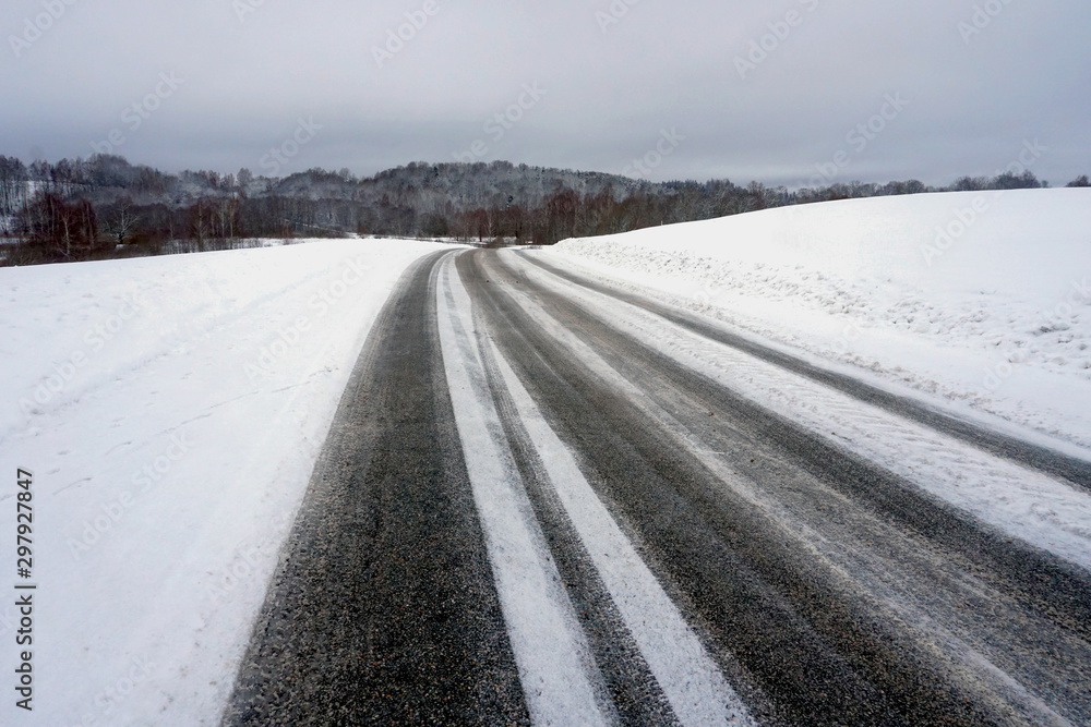 Beautiful winter landscape with snow-covered trees and road in Latvia. Beautiful winter landscape with snow-covered trees and road in Latvia.