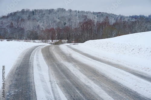 Beautiful winter landscape with snow-covered trees and road in Latvia.