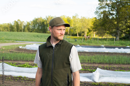 Portrait of a farmer standing in his garden