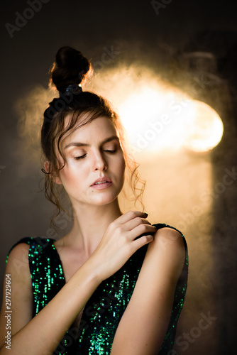 Young woman with smoke and movie light in a dark room