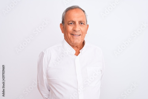 Senior grey-haired man wearing elegant shirt standing over isolated white background with a happy and cool smile on face. Lucky person.