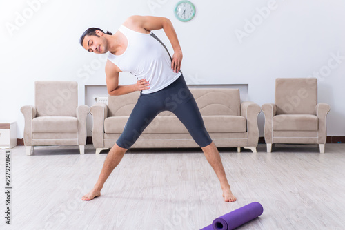 Young man training and exercising at home