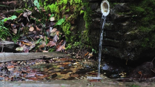 Trickle of water falls onto the stones