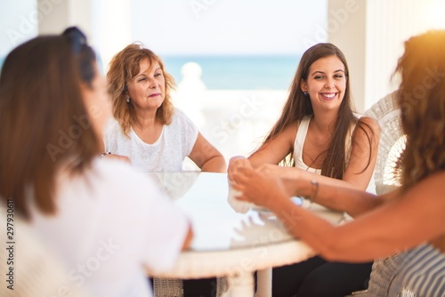 Beautiful group of women sitting at terrace speaking and smiling