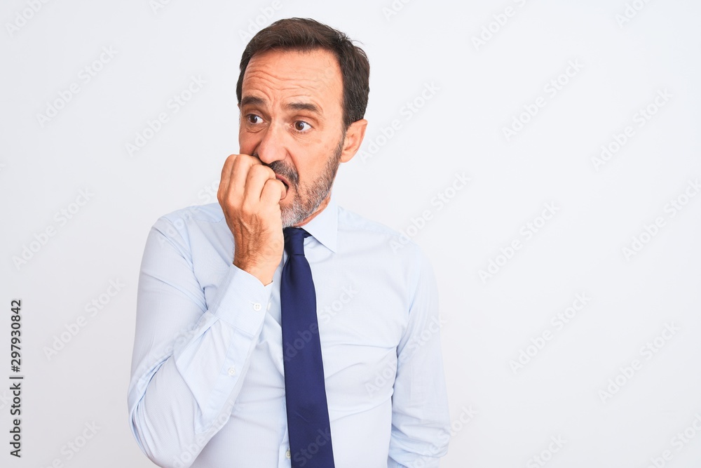 Middle age businessman wearing elegant tie standing over isolated white background looking stressed and nervous with hands on mouth biting nails. Anxiety problem. Middle age businessman wearing elegant tie standing over isolated white background looking stressed and nervous with hands on mouth biting nails. Anxiety problem.