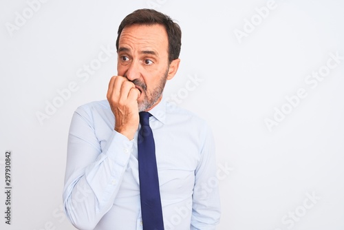Middle age businessman wearing elegant tie standing over isolated white background looking stressed and nervous with hands on mouth biting nails. Anxiety problem.