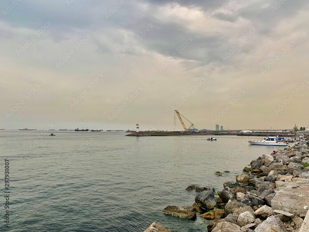 Lighthouse and fishing boats on the shores of the Sea of ​​Marmara, Istanbul, Turkey