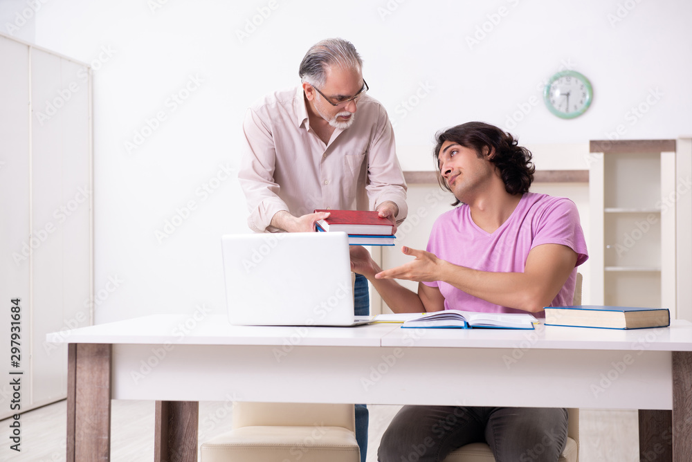 Old father helping his son in exam preparation Old father helping his son in exam preparation
