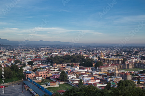 Fototapeta Naklejka Na Ścianę i Meble -  Panoramic view of the city, Popocatepetl volcano, San Gabriel Convent, the city is famous for its Great Pyramid, the largest archaeological site in the world at its base