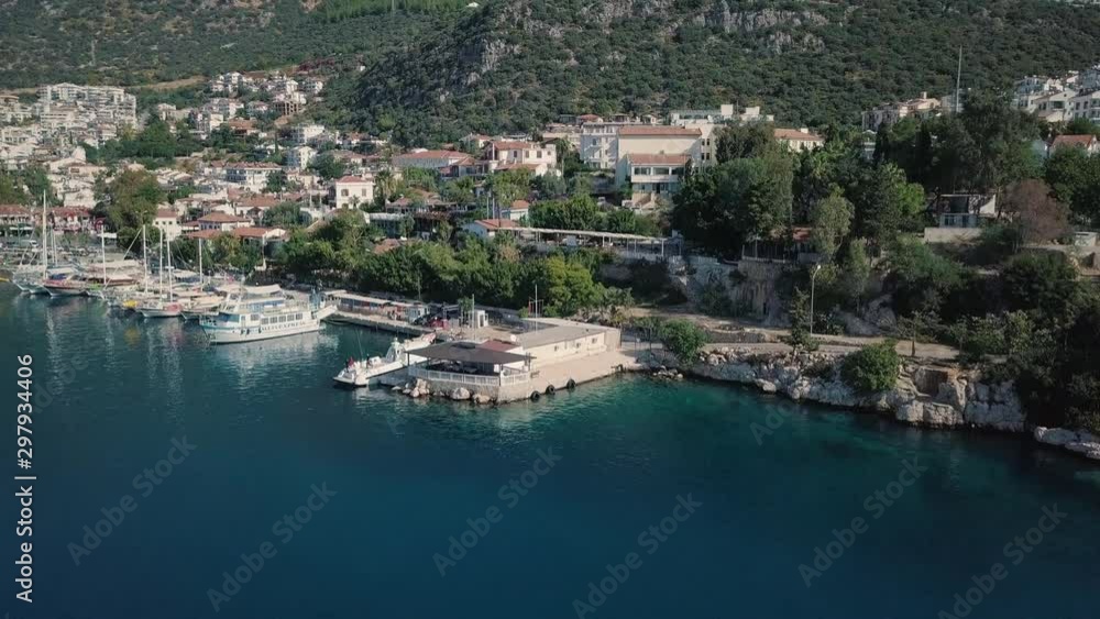 The city of Kas in Turkey on the Antalya coast of the Mediterranean Sea. Aerial view. Coastal tourist town. Yachts and pleasure boats in the port The city of Kas in Turkey on the Antalya coast of the Mediterranean Sea. Aerial view. Coastal tourist town. Yachts and pleasure boats in the port