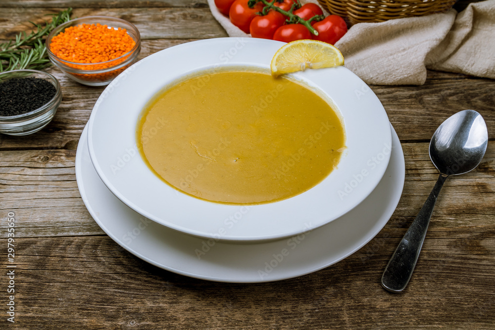 Lentil soup with lemon on wooden table. Turkish cuisine Lentil soup with lemon on wooden table. Turkish cuisine