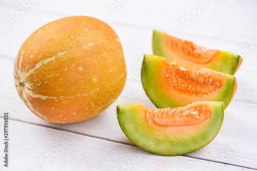 Muskmelon sliced cantaloupe thai tropical fruit asian on wood background - melon yellow