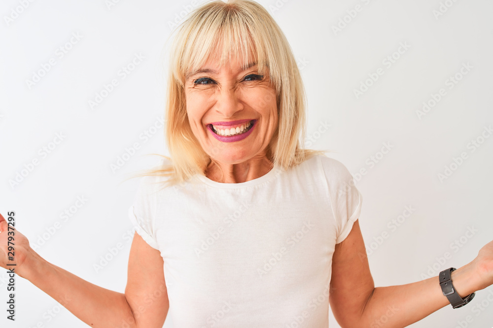 Middle age woman wearing casual t-shirt standing over isolated white background very happy and excited, winner expression celebrating victory screaming with big smile and raised hands Middle age woman wearing casual t-shirt standing over isolated white background very happy and excited, winner expression celebrating victory screaming with big smile and raised hands