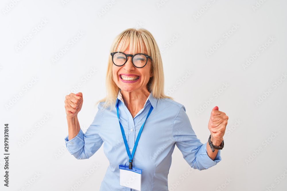 Middle age businesswoman wearing glasses and id card over isolated white background very happy and excited doing winner gesture with arms raised, smiling and screaming for success. Celebration concept Middle age businesswoman wearing glasses and id card over isolated white background very happy and excited doing winner gesture with arms raised, smiling and screaming for success. Celebration concept
