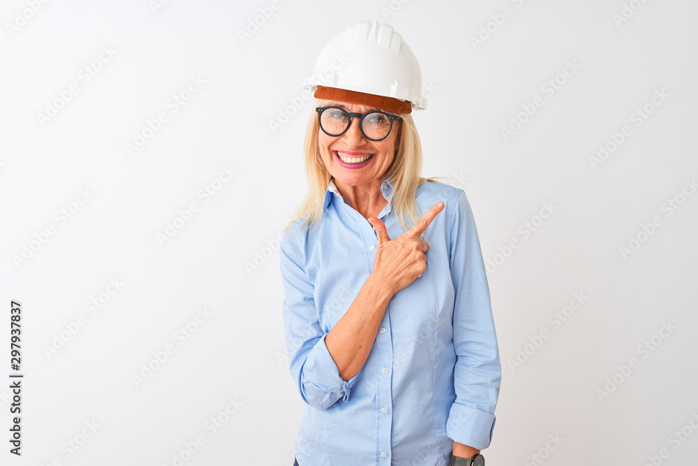 Middle age architect woman wearing glasses and helmet over isolated white background cheerful with a smile of face pointing with hand and finger up to the side with happy and natural expression 