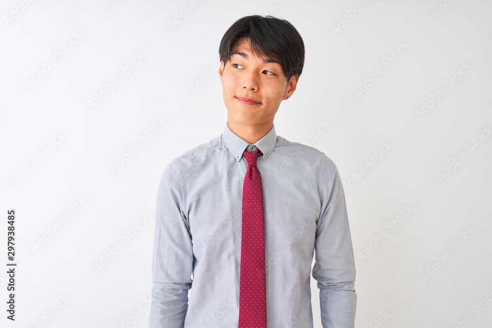Chinese businessman wearing elegant tie standing over isolated white background smiling looking to the side and staring away thinking. Chinese businessman wearing elegant tie standing over isolated white background smiling looking to the side and staring away thinking.
