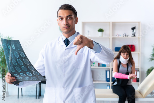 Young woman visiting male doctor traumatologist