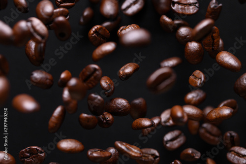 black coffee grains while cooking. Iced in the air on a black background for design