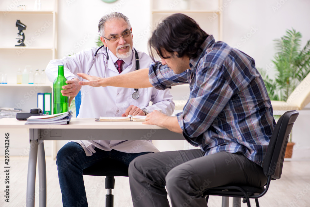 Young male alcoholic visiting old doctor Young male alcoholic visiting old doctor