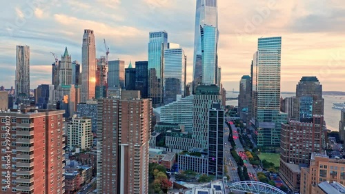 Drone footage with slow panning in front of New York City Lower Manhattan skyscrapers on a sunny afternoon before sunset