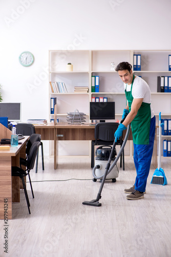 Young handsome contractor cleaning the office © Elnur